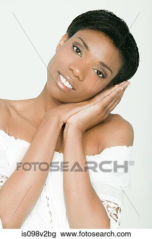 Portrait of young woman resting on hands View Large Photo Image Stock Image - Portrait of young woman resting on hands. Fotosearch
