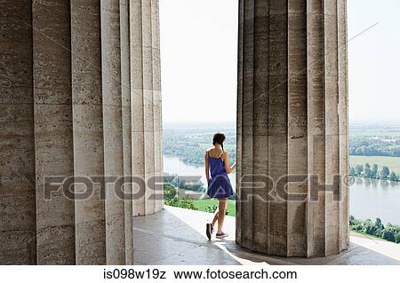 Woman by stone columns, Regensburg, Bavaria, Germany View Large Photo Image Stock Photo - Woman by stone columns, Regensburg, Bavaria, Germany. Fotosearch