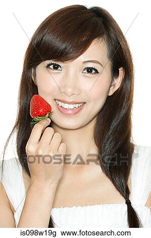 Woman holding strawberry View Large Photo Image Stock Image - Woman holding strawberry. Fotosearch