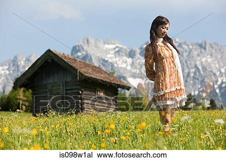 Woman in meadow with Bavarian Alps in background, Germany View Large Photo Image Stock Image - Woman in meadow with Bavarian Alps in background, Germany. Fotosearch