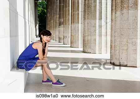 Woman sitting on stone step, Regensburg, Bavaria, Germany View Large Photo Image Stock Image - Woman sitting on stone step, Regensburg, Bavaria, Germany. Fotosearch
