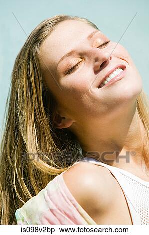 Stock Photography - Young blond woman with eyes closed. Fotosearch