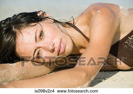 Young sexy woman lying on beach View Large Photo Image Picture - Young sexy woman lying on beach. Fotosearch