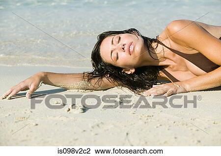Young sexy woman lying on beach View Large Photo Image Stock Image - Young sexy woman lying on beach. Fotosearch