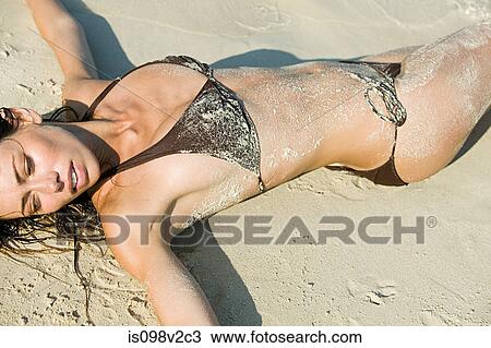 Young sexy woman lying on beach View Large Photo Image Stock Image - Young sexy woman lying on beach. Fotosearch