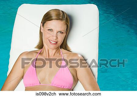 Young woman at poolside View Large Photo Image Stock Image - Young woman at poolside. Fotosearch