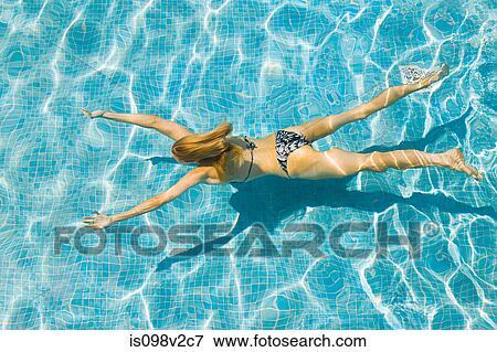 Stock Photo - Young woman swimming in swimming pool. Fotosearch
