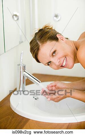 Young woman washing face View Large Photo Image Stock Image - Young woman washing face. Fotosearch