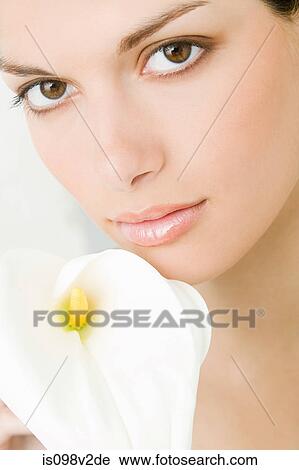 Stock Image - Young woman with lily. Fotosearch