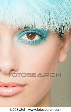 Stock Image - Young woman with turquoise eyeshadow. Fotosearch