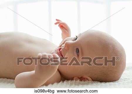 Stock Image - Baby boy lying on back. Fotosearch
