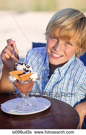 Boy with an ice cream sundae View Large Photo Image Stock Photograph - Boy with an ice cream sundae. Fotosearch
