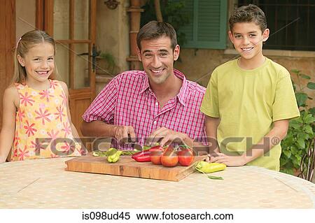 Children and father chopping vegetables outdoors View Large Photo Image Stock Photography - Children and father chopping vegetables outdoors. Fotosearch