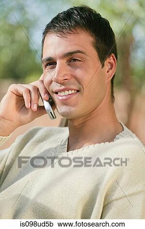 Stock Image - Close up of man using cellphone. Fotosearch