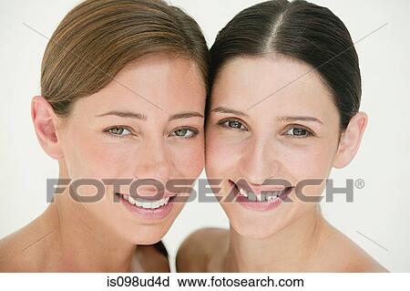 Stock Image - Faces if two young women. Fotosearch