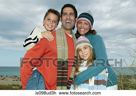 Family in warm clothes at the coast View Large Photo Image Stock Image - Family in warm clothes at the coast. Fotosearch