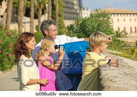 Family using telescope to look at view View Large Photo Image Stock Photo - Family using telescope to look at view. Fotosearch