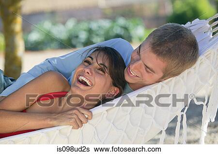 Happy couple in a hammock View Large Photo Image Stock Photograph - Happy couple in a hammock. Fotosearch