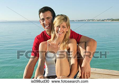 Happy couple on a jetty by the sea View Large Photo Image Stock Image - Happy couple on a jetty by the sea. Fotosearch