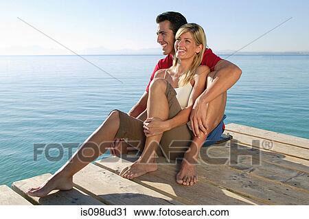 Happy couple on a jetty by the sea View Large Photo Image Stock Image - Happy couple on a jetty by the sea. Fotosearch