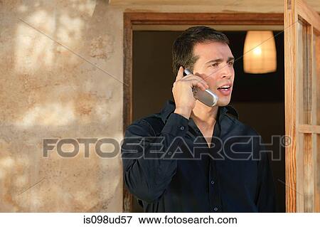 Man in a black shirt using cellphone View Large Photo Image Stock Photo - Man in a black shirt using cellphone. Fotosearch