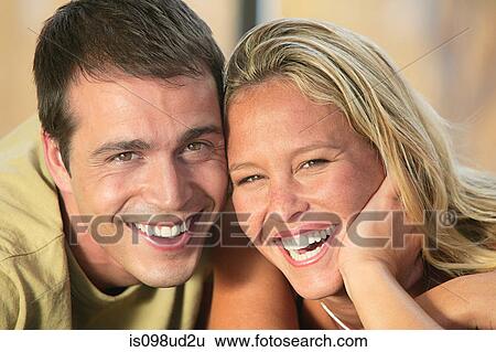 Portrait of a happy young couple View Large Photo Image Stock Photograph - Portrait of a happy young couple. Fotosearch