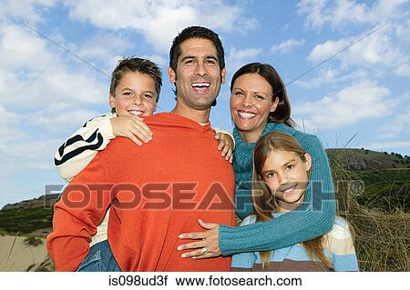 Stock Image - Two generation family outdoors. Fotosearch
