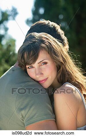 Woman hugging boyfriend View Large Photo Image Stock Image - Woman hugging boyfriend. Fotosearch
