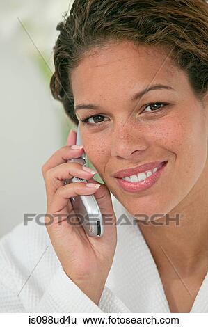 Stock Photograph - Woman using cellphone. Fotosearch