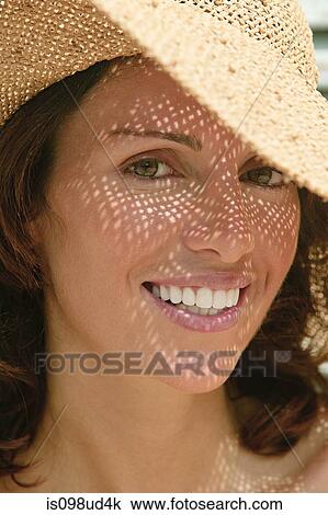 Woman wearing a sun hat with shadows on face View Large Photo Image Stock Image - Woman wearing a sun hat with shadows on face. Fotosearch