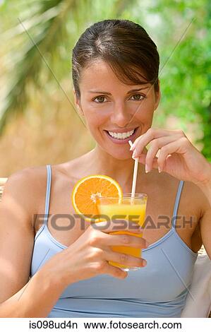 Picture - Woman with a glass of fresh orange juice. Fotosearch