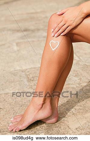 Woman with heart shape of lotion on her leg View Large Photo Image Stock Image - Woman with heart shape of lotion on her leg. Fotosearch
