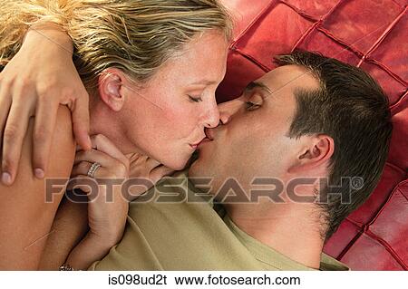 Young couple kissing View Large Photo Image Stock Photograph - Young couple kissing. Fotosearch