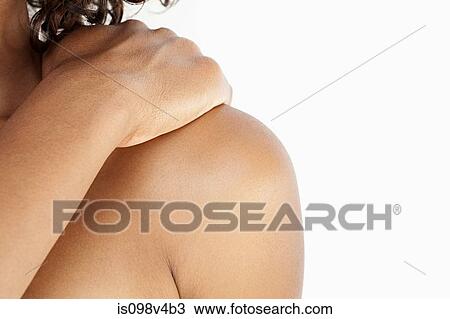 Stock Image - Young woman touching shoulder. Fotosearch