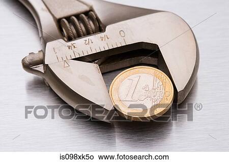 Euro coin in a wrench View Large Photo Image Picture - Euro coin in a wrench. Fotosearch