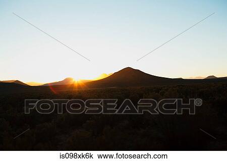 Stock Image - Sun over mountains, South Africa. Fotosearch