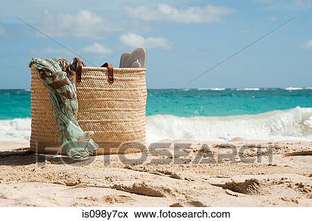 Stock Photo - Beach bag on sandy beach, Mustique, Grenadine Islands. Fotosearch