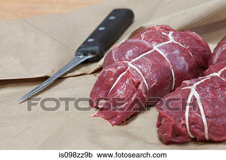 Stock Image - Beef tenderloin, rolled and tied in string. Fotosearch