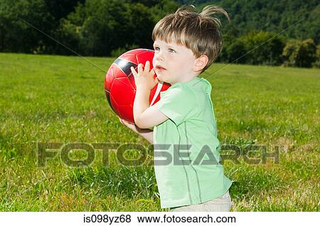 Boy holding football, portrait View Large Photo Image Stock Photo - Boy holding football, portrait. Fotosearch