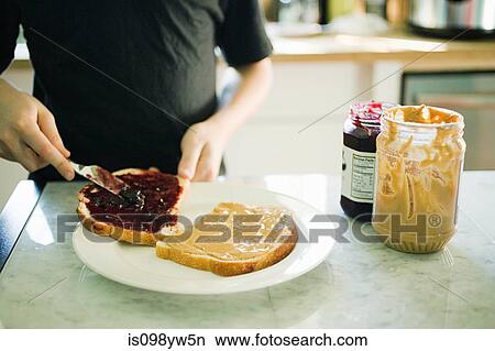 Picture - Boy making sandwich. Fotosearch