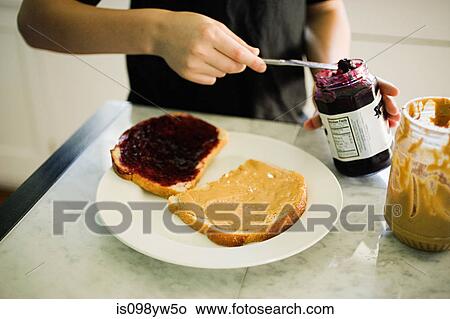Picture - Boy making sandwich. Fotosearch