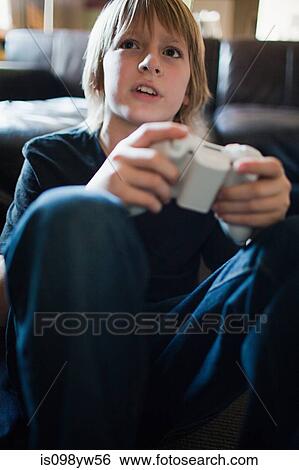 Boy playing video game View Large Photo Image Stock Photograph - Boy playing video game. Fotosearch