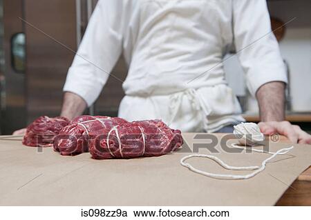 Butcher and beef tenderloin rolled and tied View Large Photo Image Stock Image - Butcher and beef tenderloin rolled and tied. Fotosearch