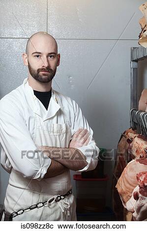 Butcher in meat storage area View Large Photo Image Stock Image - Butcher in meat storage area. Fotosearch