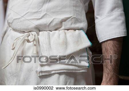 Stock Image - Butcher in uniform, close up. Fotosearch