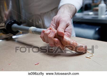 Butcher making a sausage View Large Photo Image Stock Photo - Butcher making a sausage. Fotosearch