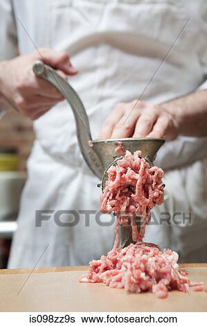 Butcher making mince View Large Photo Image Stock Photograph - Butcher making mince. Fotosearch