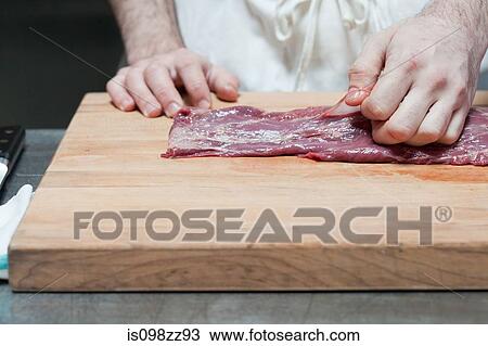 Butcher preparing beef tenderloin View Large Photo Image Stock Image - Butcher preparing beef tenderloin. Fotosearch