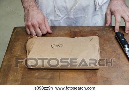 Butcher with package of ribs View Large Photo Image Stock Image - Butcher with package of ribs. Fotosearch