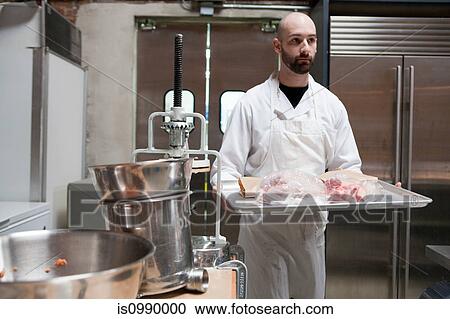 Butcher with tray of meat View Large Photo Image Stock Image - Butcher with tray of meat. Fotosearch